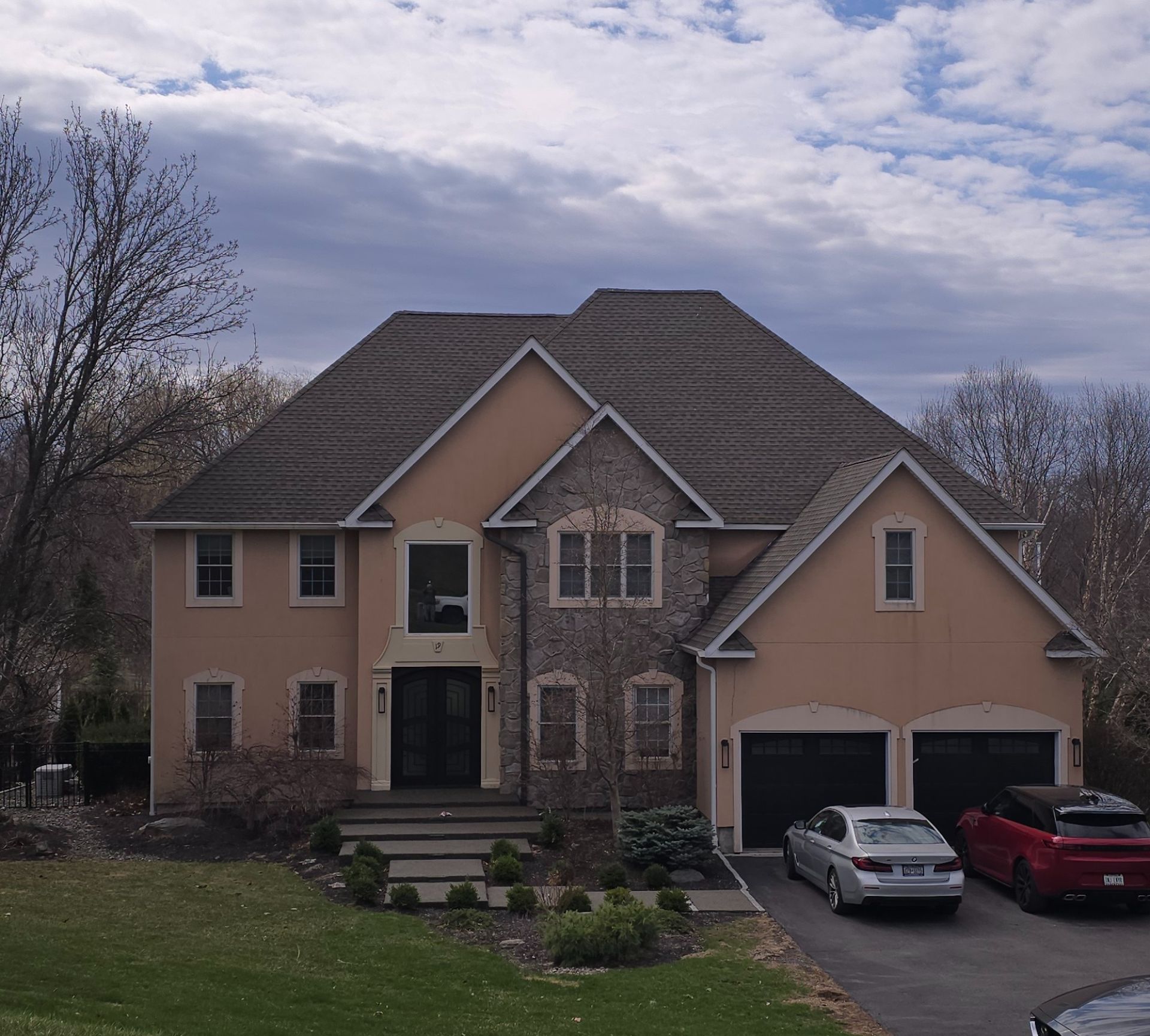 Aerial view of a suburban house with a pool, surrounded by green lawns and autumn trees, in Tipton, Indiana.
